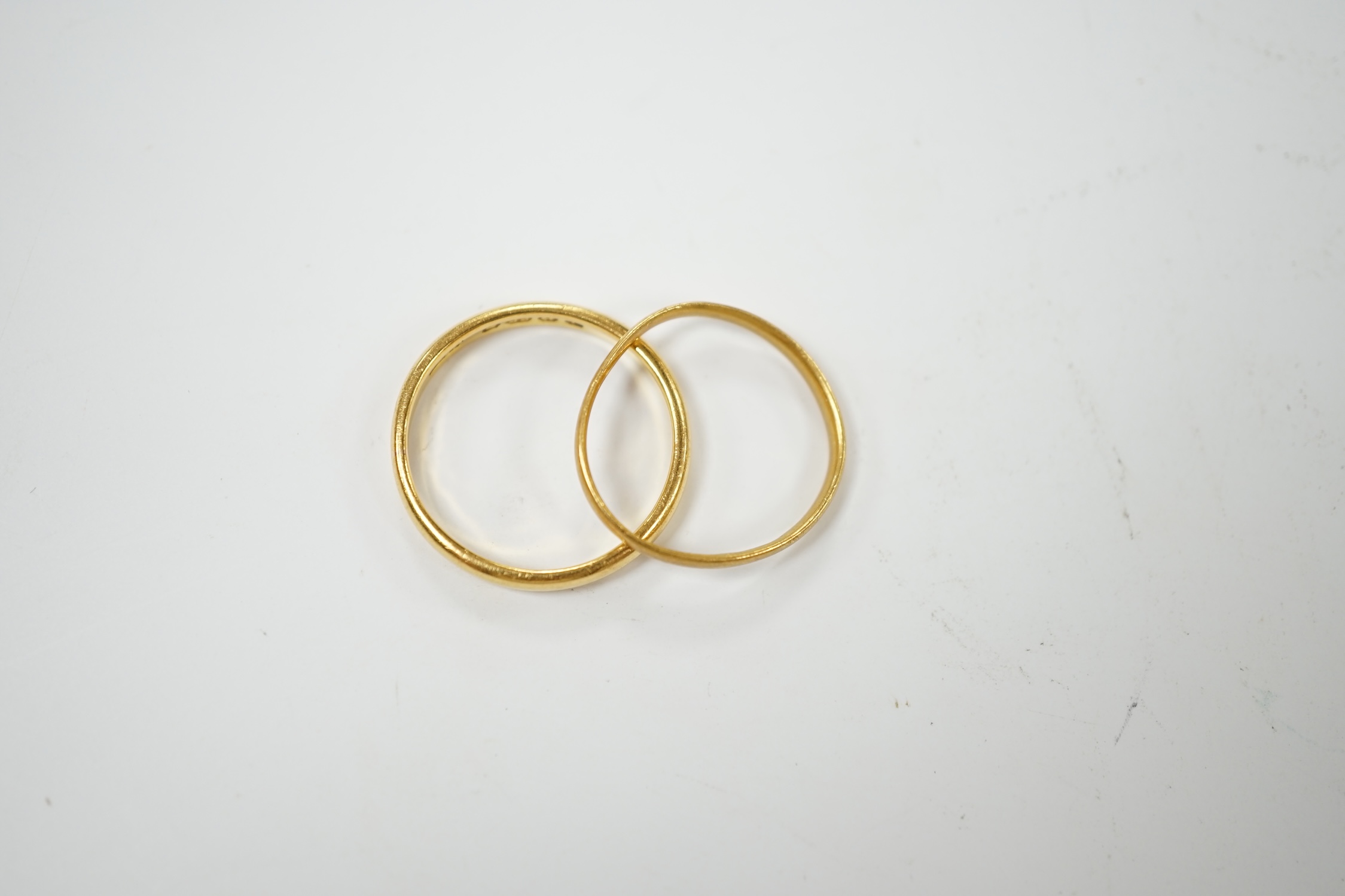 Two 22ct gold wedding bands, 4.3 grams. Condition - fair